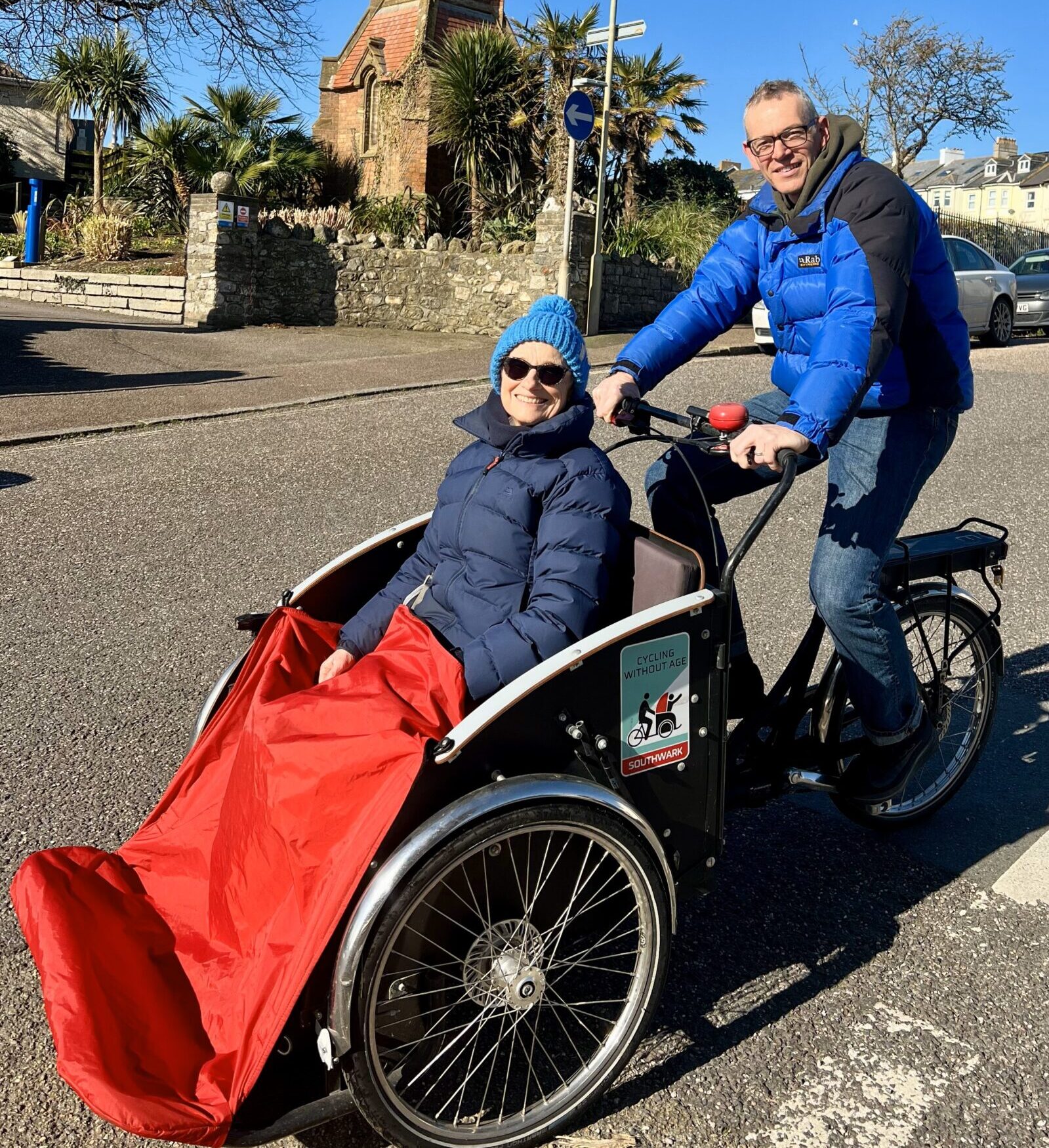 2 Seaton Cycling Without Age Trustees on the Trishaw in front of the Seafield Gardens in the lovely Seaton Devon