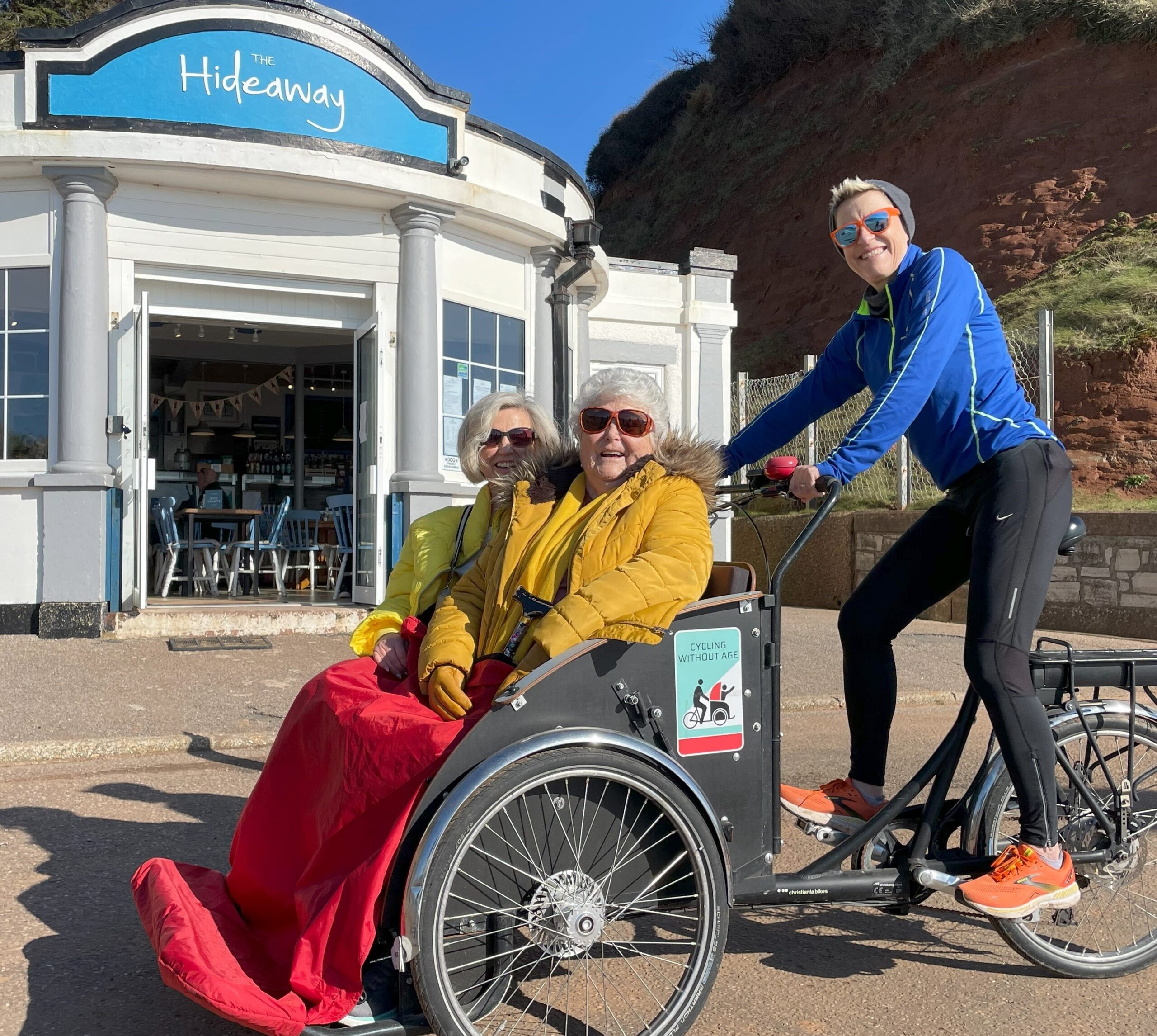 Seaton Mother & Daughter on Trishaw outside The Hideaway Café on the Seaton promenade